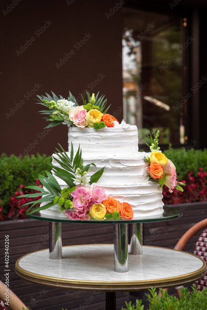 Luxurious wedding or St. Valentine's naked cake decorated with fresh flowers Luxurious wedding or St. Valentine's naked cake decorated with fresh flowers