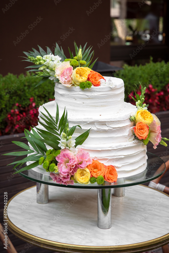 Luxurious wedding or St. Valentine's naked cake decorated with fresh flowers Luxurious wedding or St. Valentine's naked cake decorated with fresh flowers