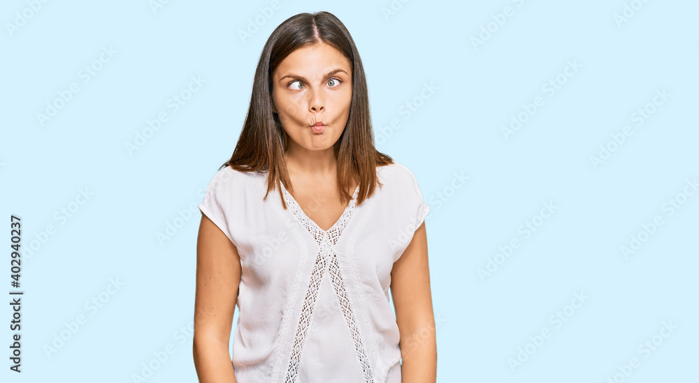 Young caucasian woman wearing casual clothes making fish face with lips, crazy and comical gesture. funny expression. Young caucasian woman wearing casual clothes making fish face with lips, crazy and comical gesture. funny expression.