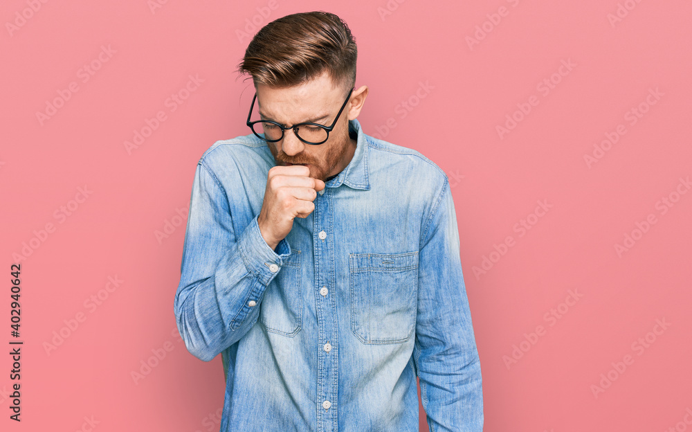 Young redhead man wearing casual denim shirt feeling unwell and coughing as symptom for cold or bronchitis. health care concept.