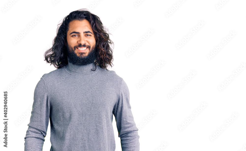Young arab man wearing casual clothes with a happy and cool smile on face. lucky person. Young arab man wearing casual clothes with a happy and cool smile on face. lucky person.