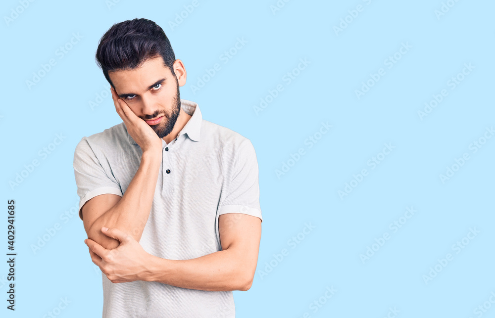 Young handsome man with beard wearing casual polo thinking looking tired and bored with depression problems with crossed arms. Young handsome man with beard wearing casual polo thinking looking tired and bored with depression problems with crossed arms.