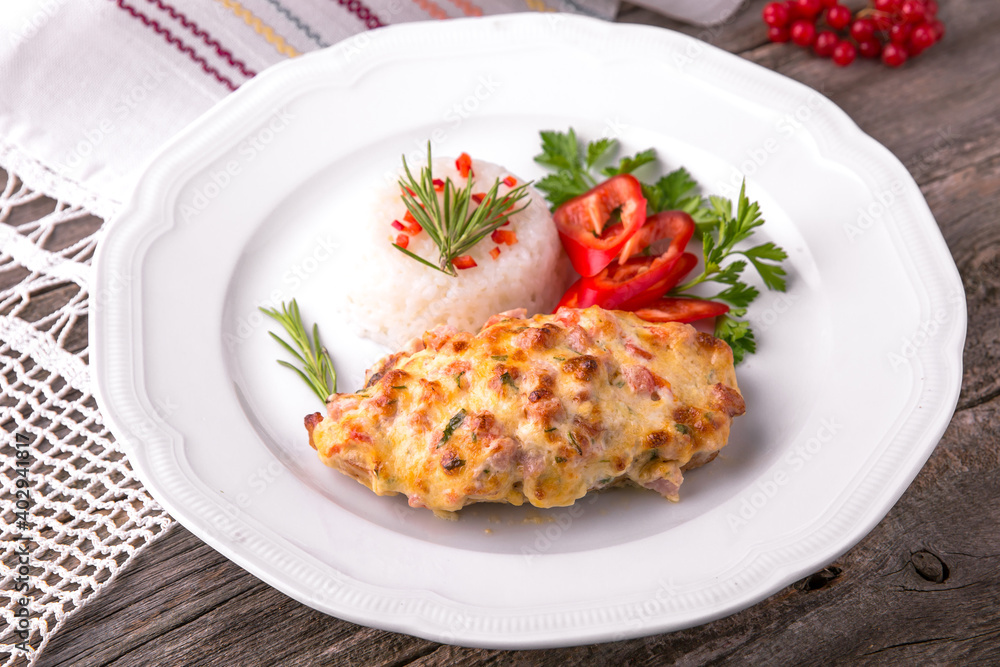 Chicken fillet baked in cheese with rice and vegetables. Balkan cuisine. National cuisine. Nourishing, useful, natural. Rustic cuisine. Chicken fillet baked in cheese with rice and vegetables. Balkan cuisine. National cuisine. Nourishing, useful, natural. Rustic cuisine.