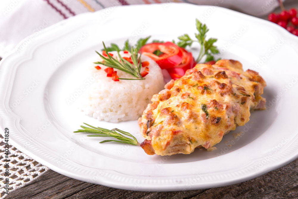 Chicken fillet baked in cheese with rice and vegetables. Balkan cuisine. National cuisine. Nourishing, useful, natural. Rustic cuisine. Chicken fillet baked in cheese with rice and vegetables. Balkan cuisine. National cuisine. Nourishing, useful, natural. Rustic cuisine.