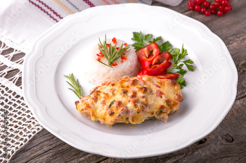 Chicken fillet baked in cheese with rice and vegetables. Balkan cuisine. National cuisine. Nourishing, useful, natural. Rustic cuisine.