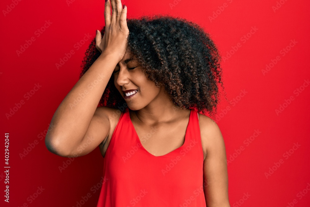 Beautiful african american woman with afro hair wearing casual clothes surprised with hand on head for mistake, remember error. forgot, bad memory concept. Beautiful african american woman with afro hair wearing casual clothes surprised with hand on head for mistake, remember error. forgot, bad memory concept.