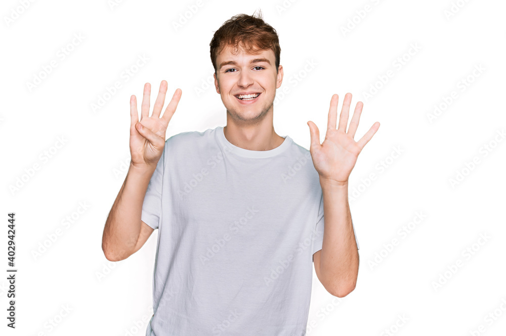 Young caucasian man wearing casual white t shirt showing and pointing up with fingers number nine while smiling confident and happy. Young caucasian man wearing casual white t shirt showing and pointing up with fingers number nine while smiling confident and happy.