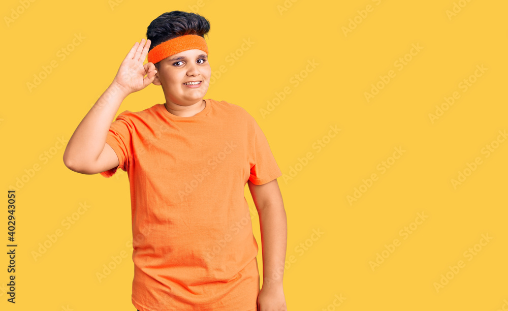 Fototapeta premium Little boy kid wearing sportswear smiling positive doing ok sign with hand and fingers. successful expression.