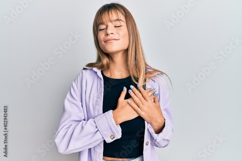 Teenager caucasian girl wearing casual clothes smiling with hands on chest, eyes closed with grateful gesture on face. health concept.