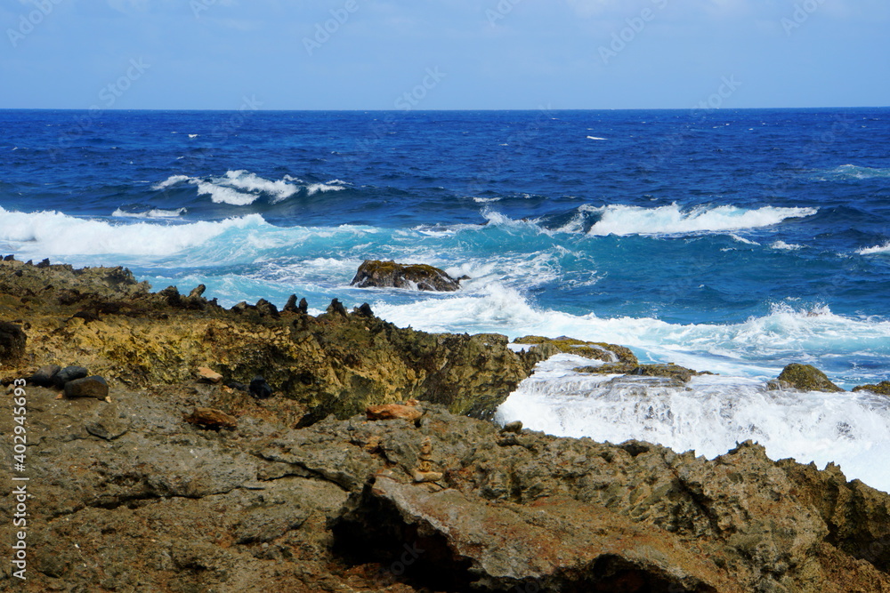 Rocky cliffs with rough waves at Andicuri Beach, Aruba
