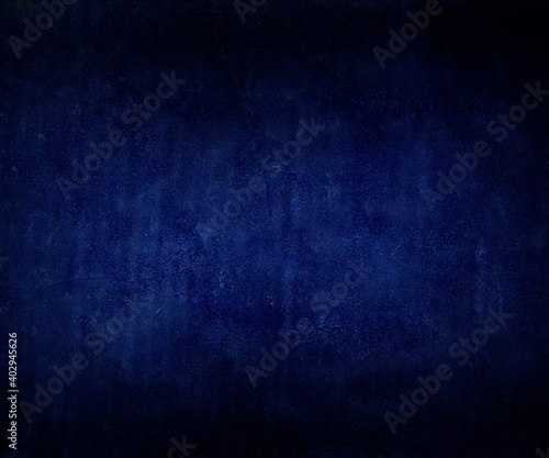 Porous aged plaster cobalt blue background web square banner texture, old distressed vintage grunge in faded spotlight design in center. Gradient vivid sandstone wall color abstract design.