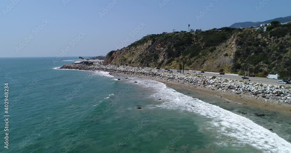Drone shot what Big Dume Beach with town on the hill at California Drone shot what Big Dume Beach with town on the hill at California