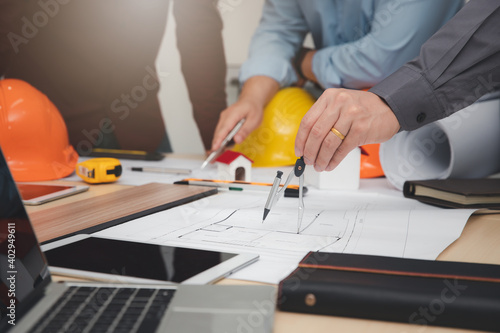 Engineer and Architect concept, Engineer Architects and Interior designer working with blueprints
