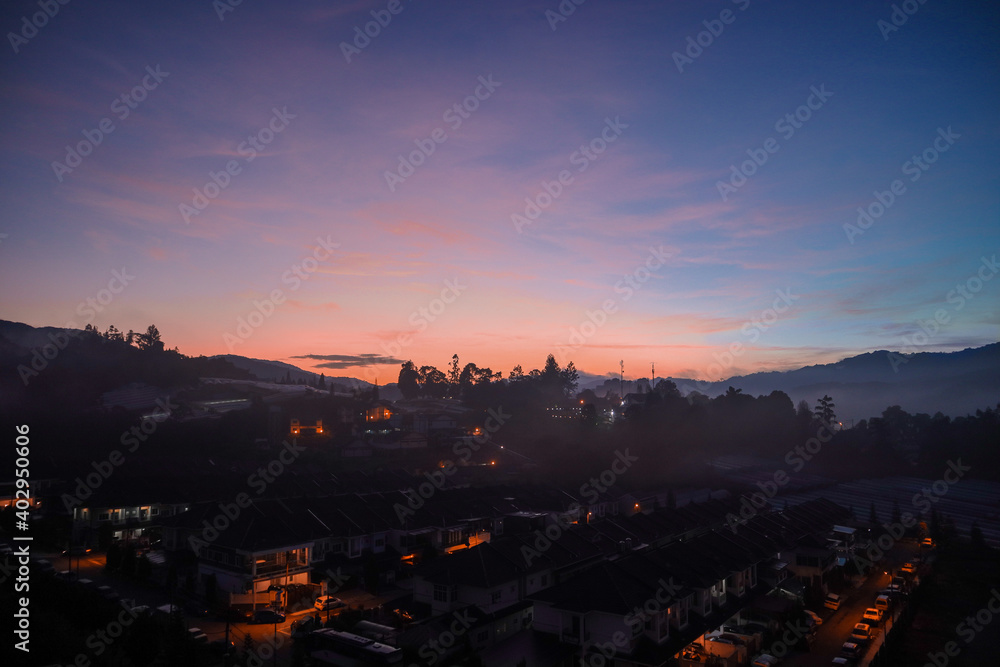 sunrise over the city with purple sky