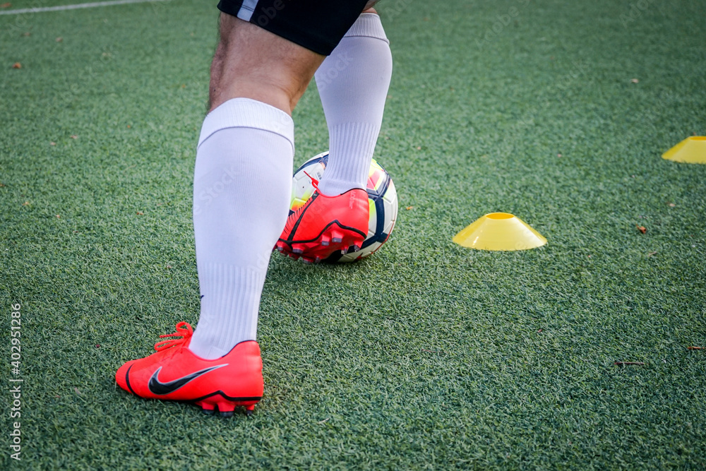 Bangkok / Thailand - May 2019 : A player is training football on pitch by  wearing nike "Phantom Venom