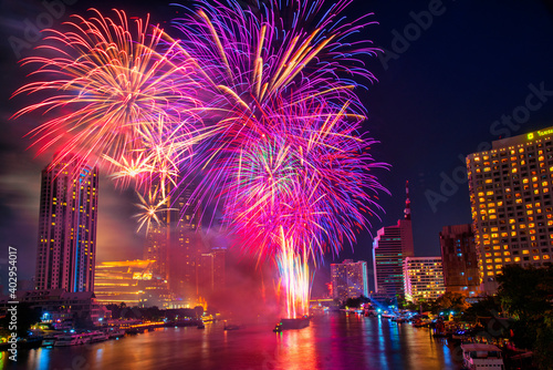 Fantastic Multicolor Firework exploding over the Bangkok Cityscape river side for Celebration, Business architecture and celebration and happy new year and merry Christmas concept
