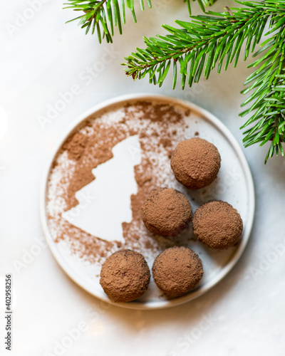 Chocolate truffles and cocoa powder on christmas background