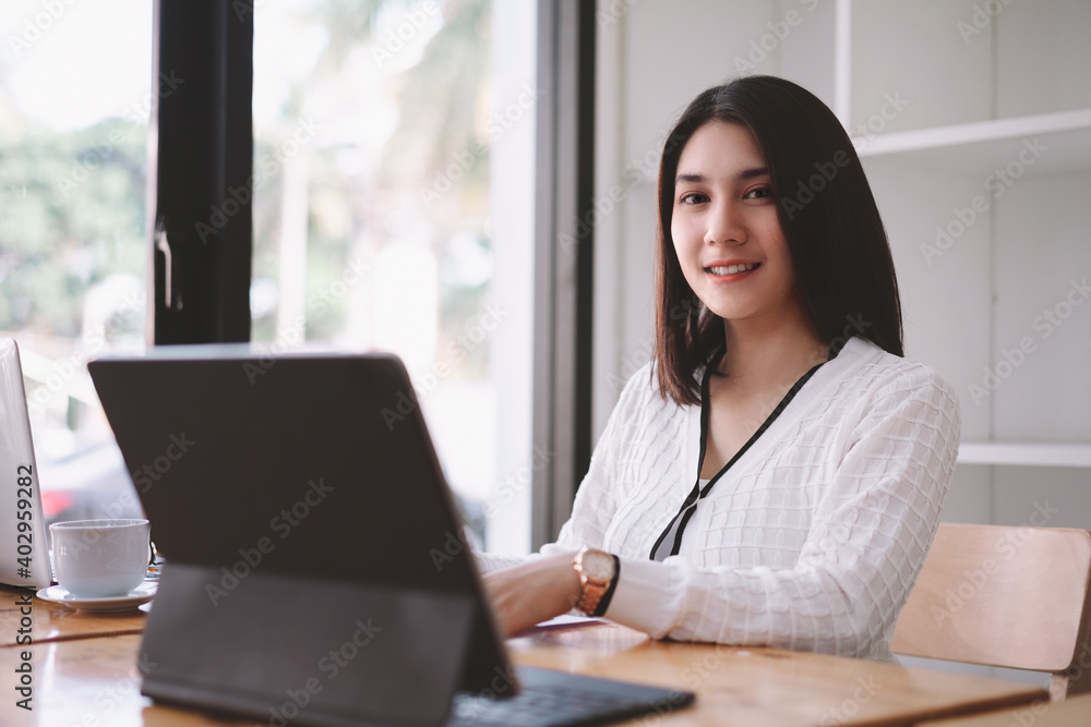 Beautiful young asian freelancer business woman working with computer laptop in co-working space or coffee shop. Beautiful young asian freelancer business woman working with computer laptop in co-working space or coffee shop.