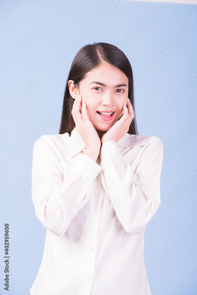 Businesswoman with a stern face on a blue background, studio portrait. Businesswoman with a stern face on a blue background, studio portrait.