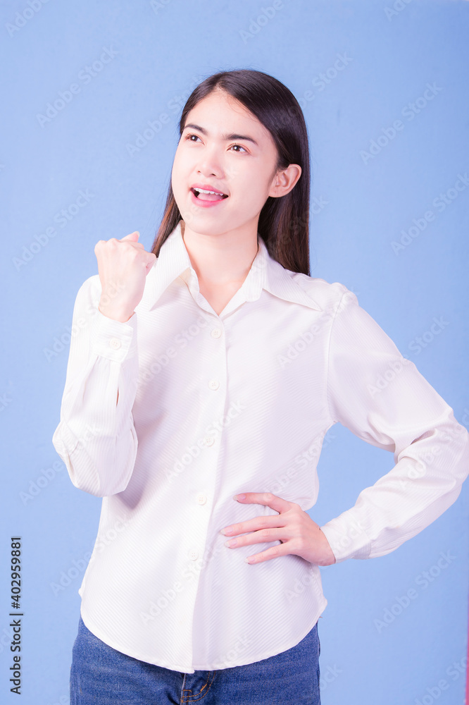 Businesswoman with a stern face on a blue background, studio portrait. Businesswoman with a stern face on a blue background, studio portrait.