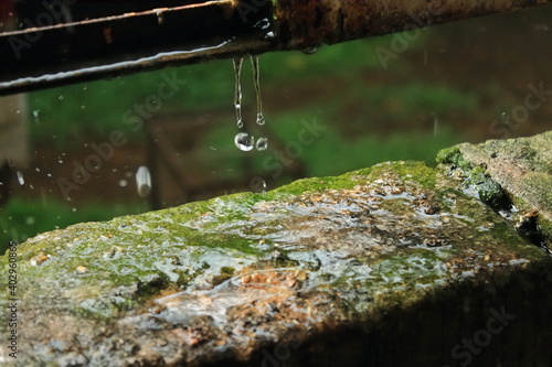 Heavy rain outdoors. Water droplets splashing from the bricks. isolated raindrops