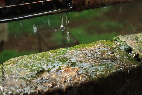 Heavy rain outdoors. Water droplets splashing from the bricks. Heavy rain
