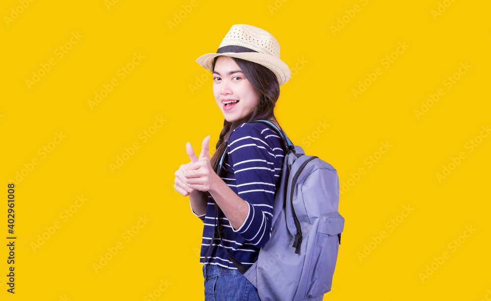 Asian woman tourist was running her to various places.happy excited emotional young woman photographer tourist standing isolated over Orange background Asian woman tourist was running her to various places.happy excited emotional young woman photographer tourist standing isolated over Orange background
