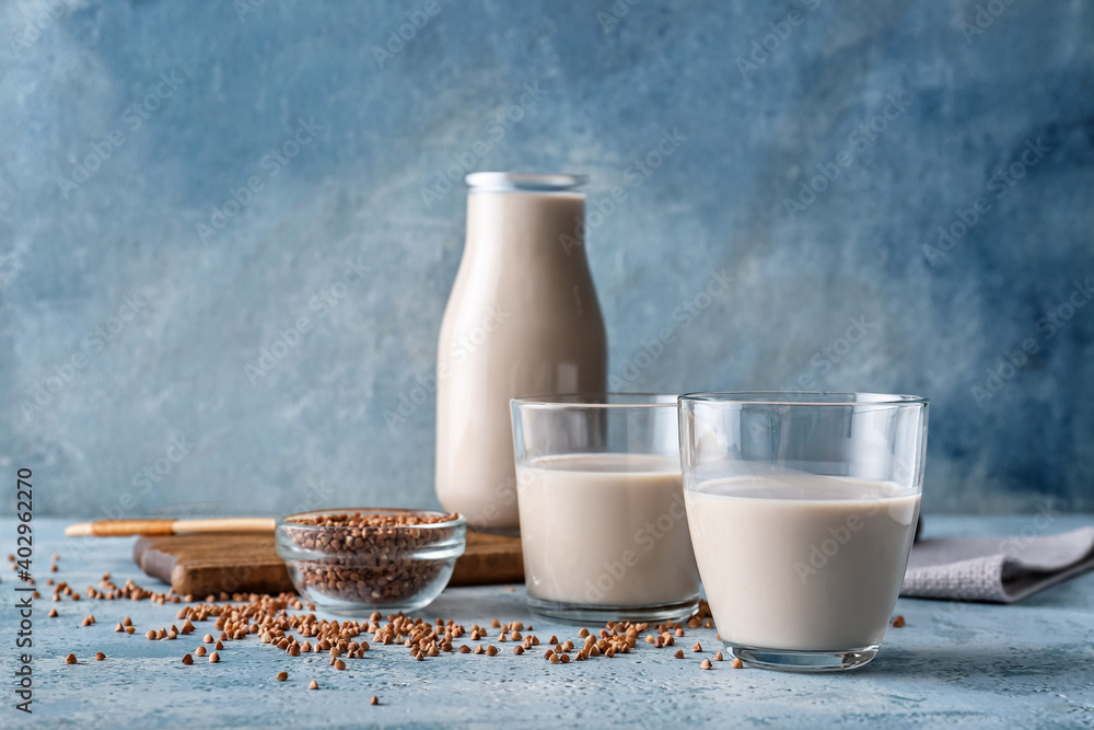 Glasses of buckwheat milk on table - obrazy, fototapety, plakaty 