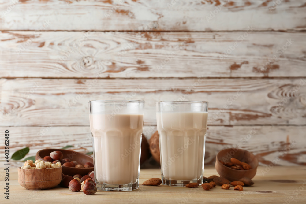 Glasses of tasty vegan milk on table - obrazy, fototapety, plakaty 