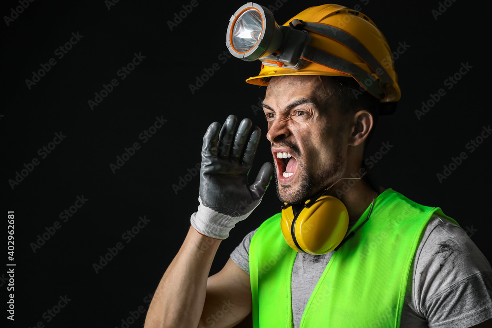 Protesting miner man on dark background