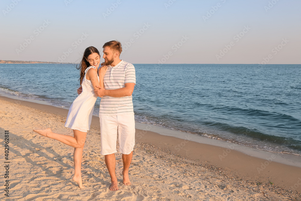 Happy young couple on sea beach Happy young couple on sea beach