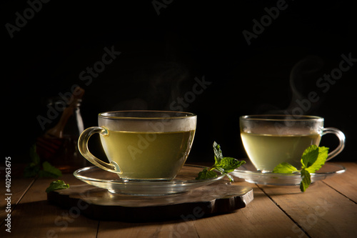 green tea with mint leaf on wooden table 