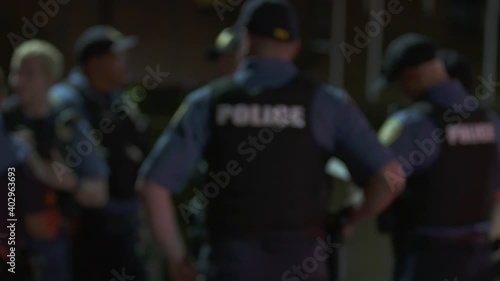 Police Group Meeting Outside at Night Blurry 4K