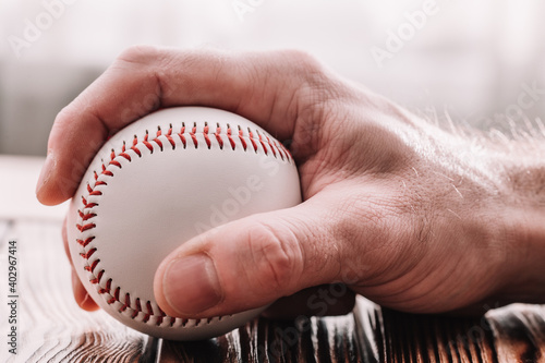 Male hand grabbing a baseball - pitcher technique in play photo