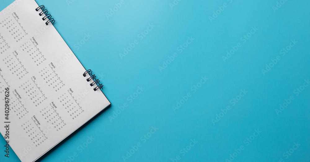 Calendar on solid blue background with copy space, business meeting schedule, travel planning or project milestone and reminder concept. Calendar on solid blue background with copy space, business meeting schedule, travel planning or project milestone and reminder concept.