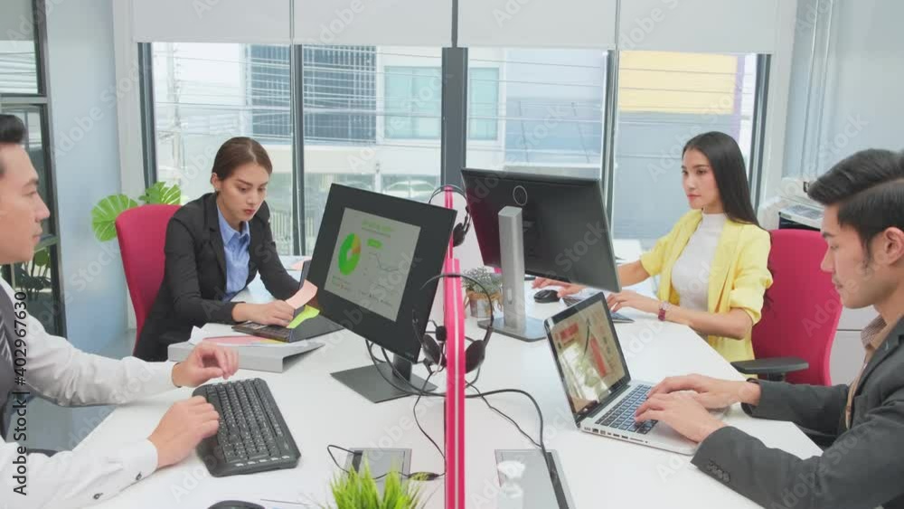 Group of Asian business people working on computer in the office. Group of Asian business people working on computer in the office.