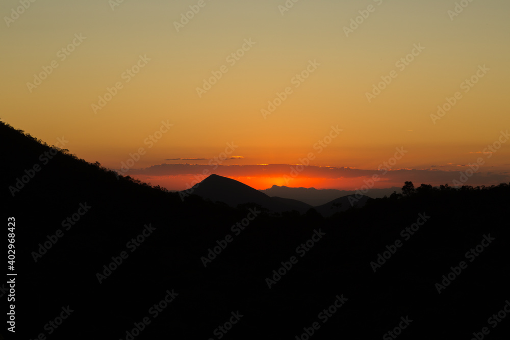 orange sky during sunset in the mountains between Teresopolis and Petropolis in the State of Rio de Janeiro in Brazil