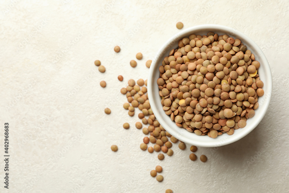 Bowl with legumes on white textured background Bowl with legumes on white textured background