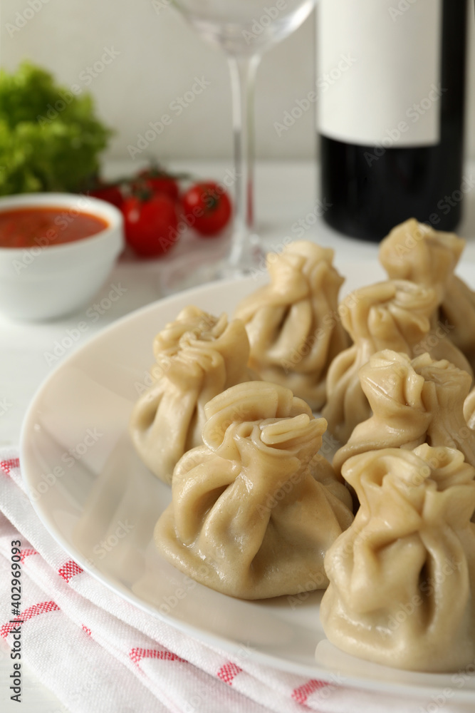 Concept of tasty lunch with plate of khinkali, close up Concept of tasty lunch with plate of khinkali, close up