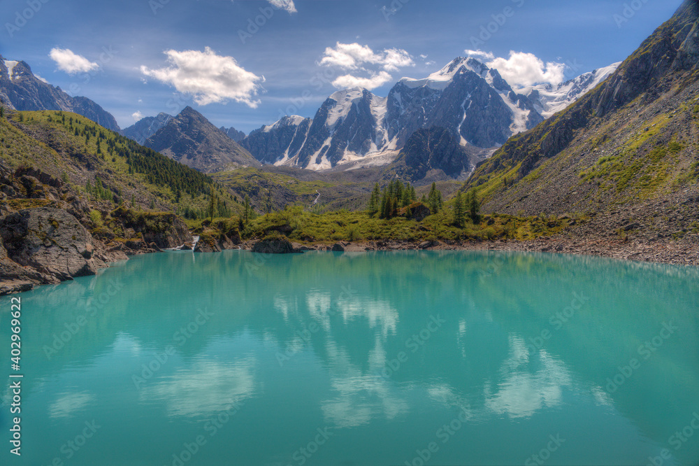 A beautiful lake in a mountain valley. Mountains, sky with clouds. Natural background.