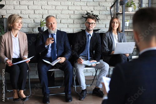 Job interview with the employer, businessman listen to candidate answers. photo