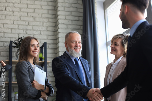 Wallpaper Mural Business people shaking hands, finishing up a meeting. Torontodigital.ca