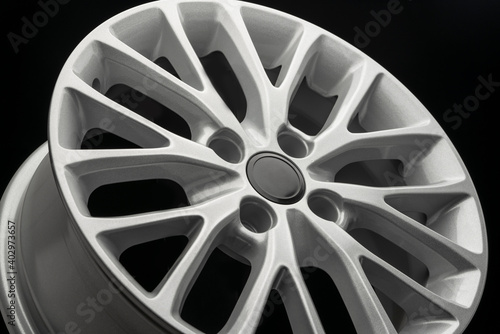 silver new alloy wheel for car, side view close-up