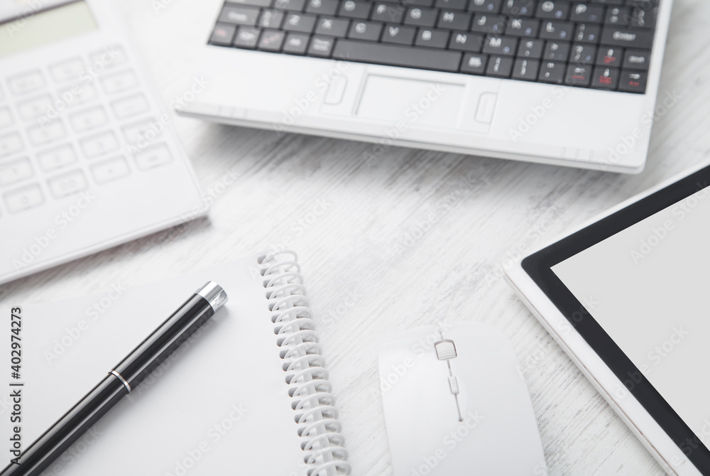 White laptop on the white business desk. Business workplace White laptop on the white business desk. Business workplace