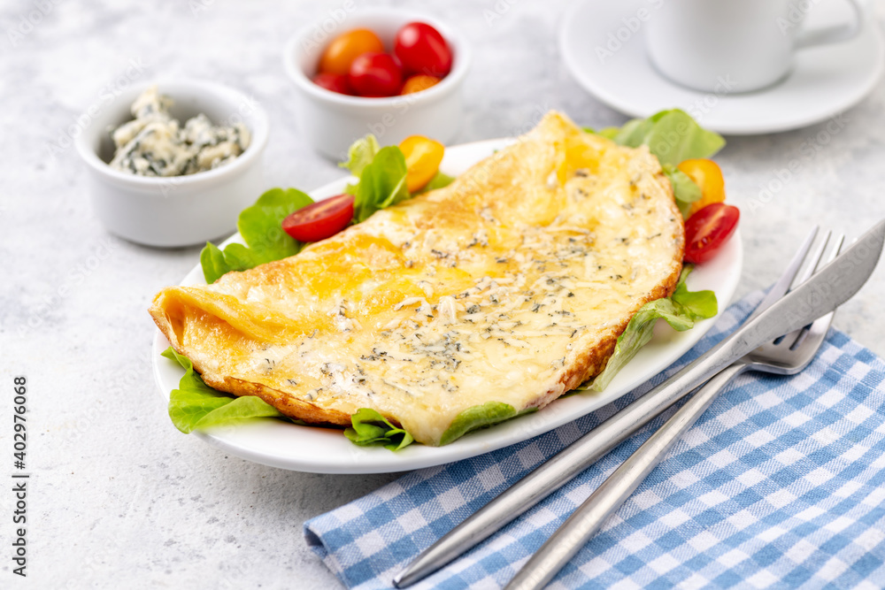 Fried eggs with cheese, cherry tomatoes and fresh lettuce.