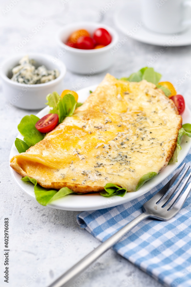 Fried eggs with cheese, cherry tomatoes and fresh lettuce. Fried eggs with cheese, cherry tomatoes and fresh lettuce.