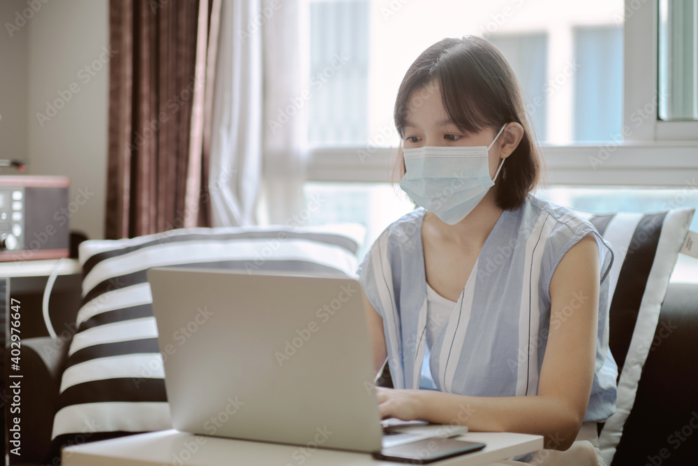 Asian women and face mask working at home in covid-19 crisis