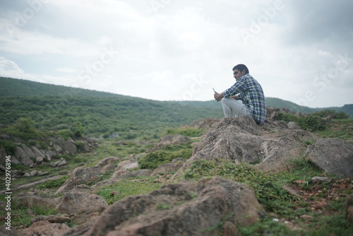 young man at hilly roads and mountains