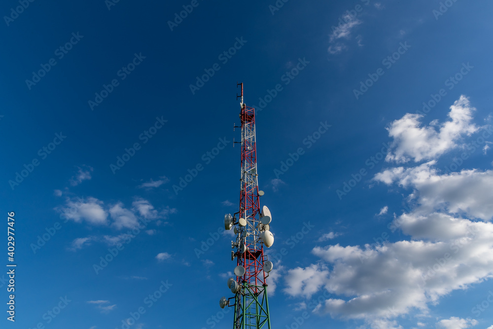 Broadcast wireless signal transmission tower in the background of blue sky and white clouds. Broadcast wireless signal transmission tower in the background of blue sky and white clouds.