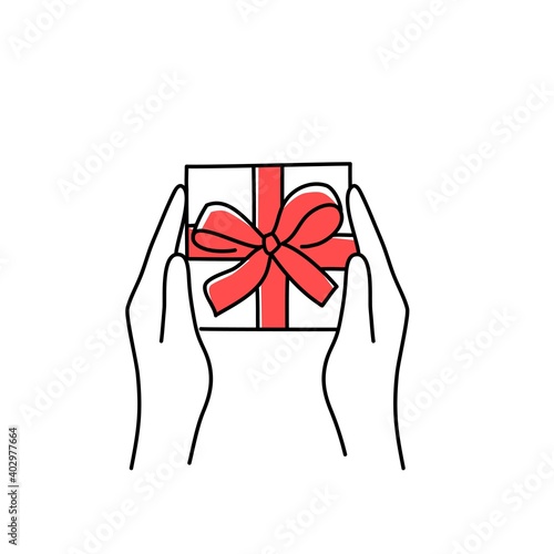 Hands holding gift box with bow.